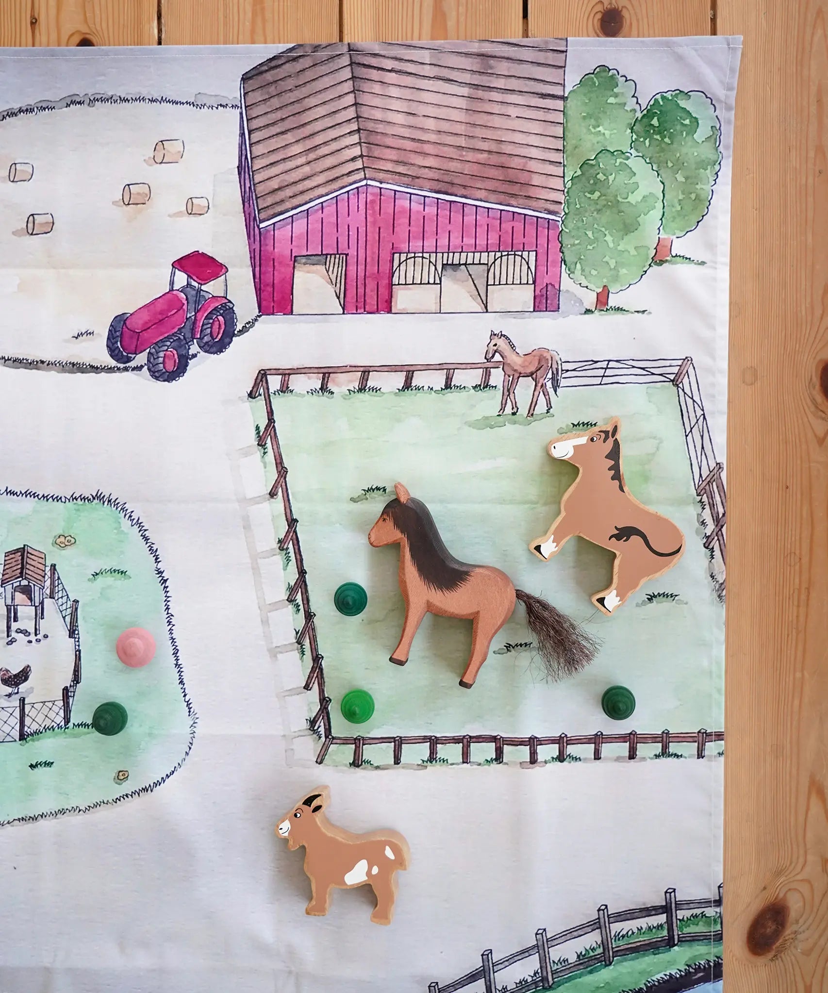 Wonderie cotton play cloth with farm design featuring a horse paddock with Ostheimer and Lanka Kade toy horses.