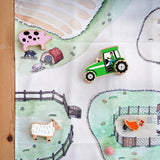 Wonderie cotton play cloth with farm design featuring a pig stye and chicken coops with Lanka Kade farm figures.