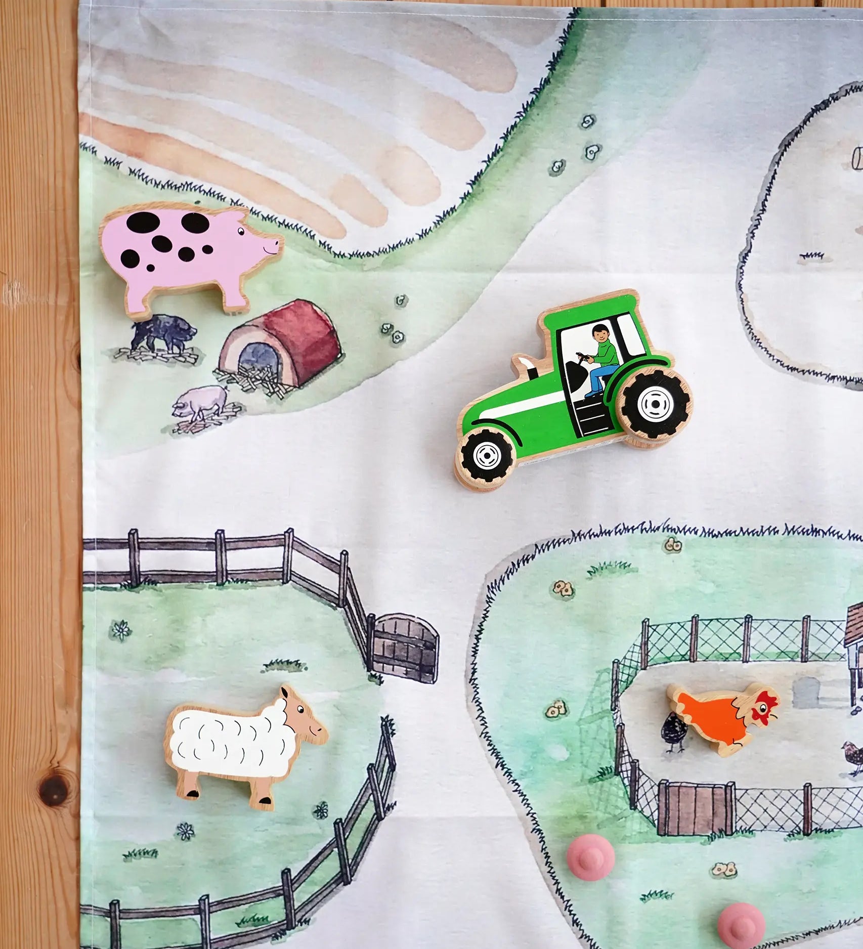 Wonderie cotton play cloth with farm design featuring a pig stye and chicken coops with Lanka Kade farm figures.