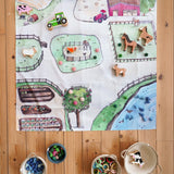 Wonderie cotton play cloth with an around the farm design, paired with Lanka Kade farm animals, Ostheimer horse and Grapat mandala pieces.
