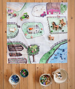 Wonderie cotton play cloth with an around the farm design, paired with Lanka Kade farm animals, Ostheimer horse and Grapat mandala pieces.
