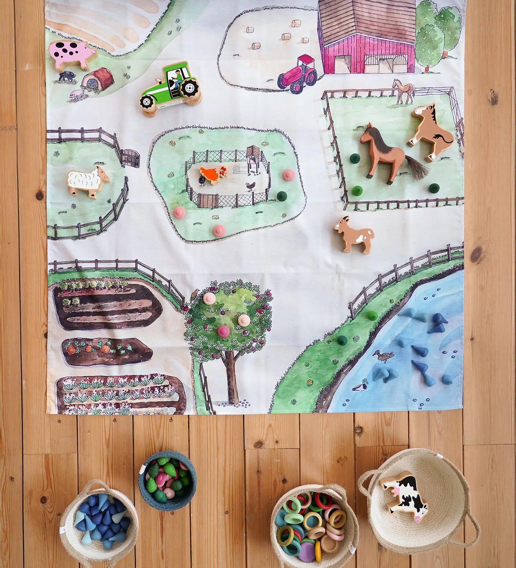 Wonderie cotton play cloth with an around the farm design, paired with Lanka Kade farm animals, Ostheimer horse and Grapat mandala pieces.