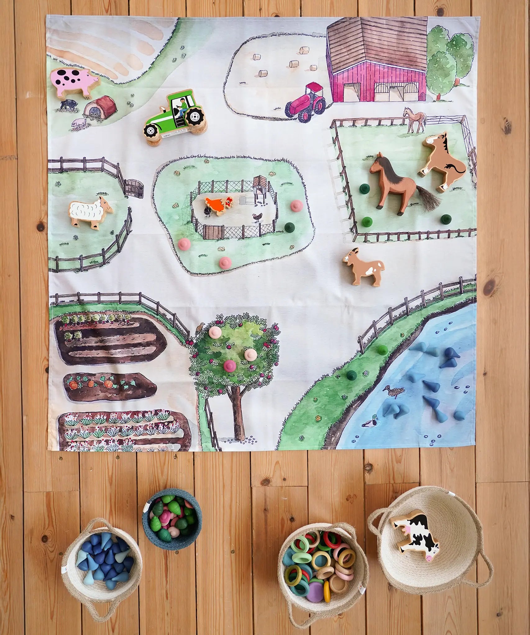 Wonderie cotton play cloth with an around the farm design, paired with Lanka Kade farm animals, Ostheimer horse and Grapat mandala pieces.