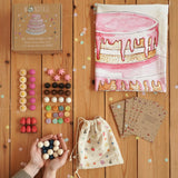 Wonderie everlasting birthday cake play cloth with Grapat 60 wooden play pieces, a drawstring bag and cotton drawstring bag.