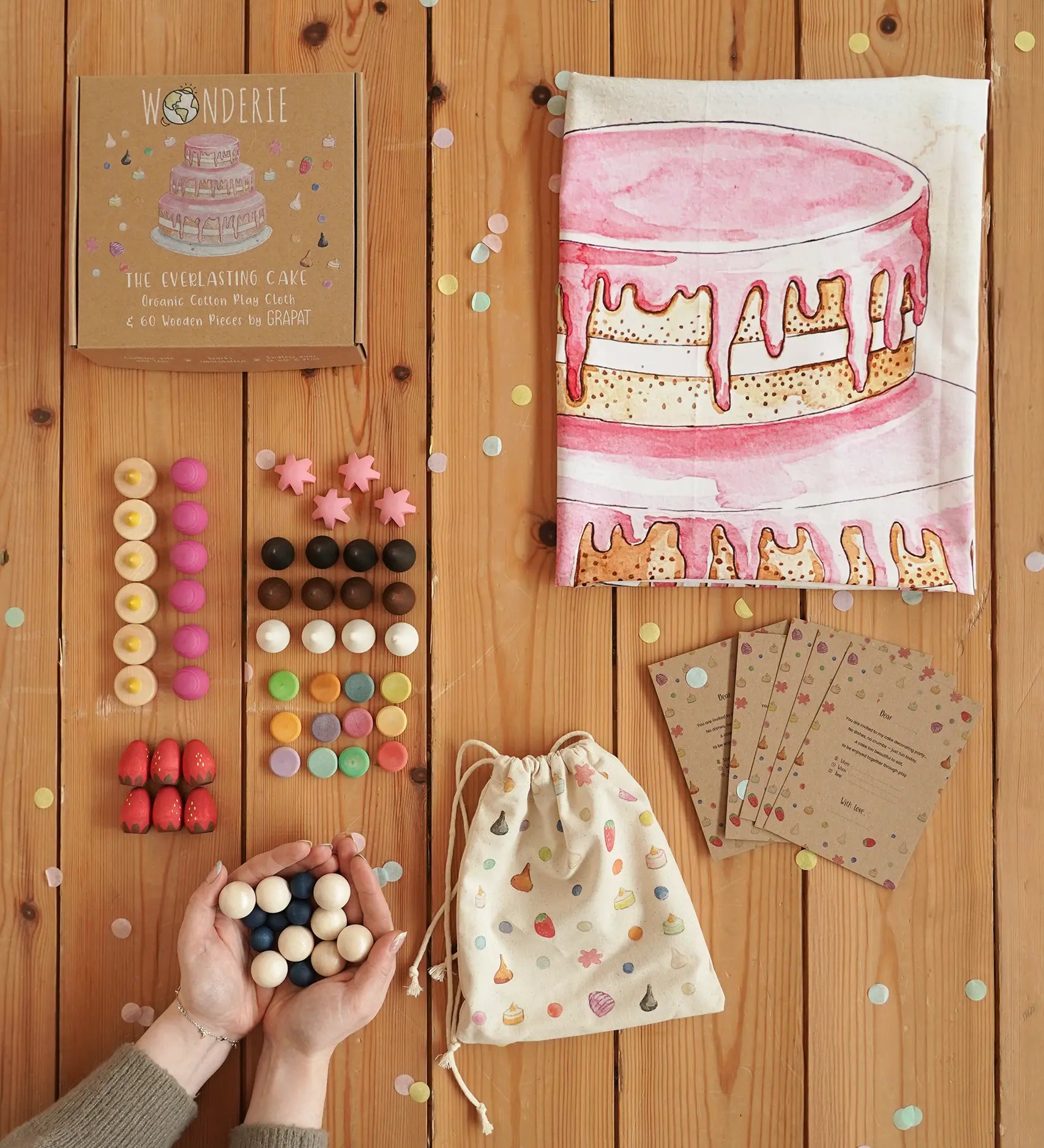 Wonderie everlasting birthday cake play cloth with Grapat 60 wooden play pieces, a drawstring bag and cotton drawstring bag.