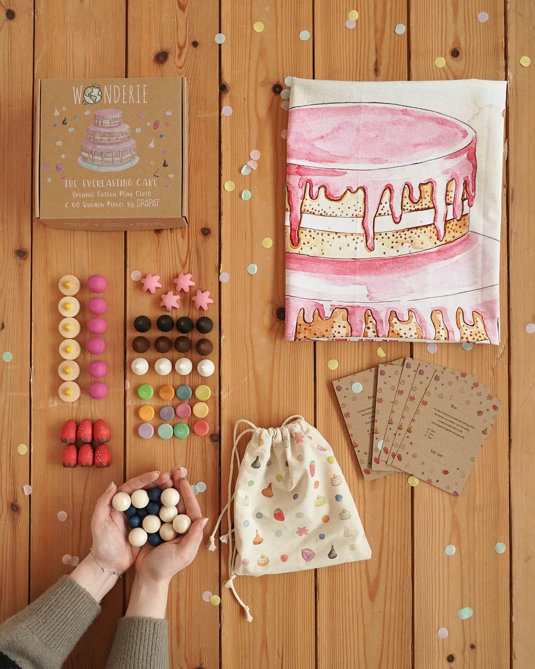 Wonderie everlasting birthday cake play cloth with Grapat 60 wooden play pieces, a drawstring bag and cotton drawstring bag.