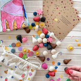 Wonderie cake play cloth set with 60 wooden Grapat play food pieces and invitations.