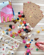 Wonderie cake play cloth set with 60 wooden Grapat play food pieces and invitations.