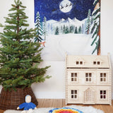 Wonderie Christmas Cotton Play Cloth, One Starry Winter's Night, a snowy forest scene with Santa and his sleigh in the Babipur playroom next to a PlanToys Victorian Dollhouse and Christmas tree.