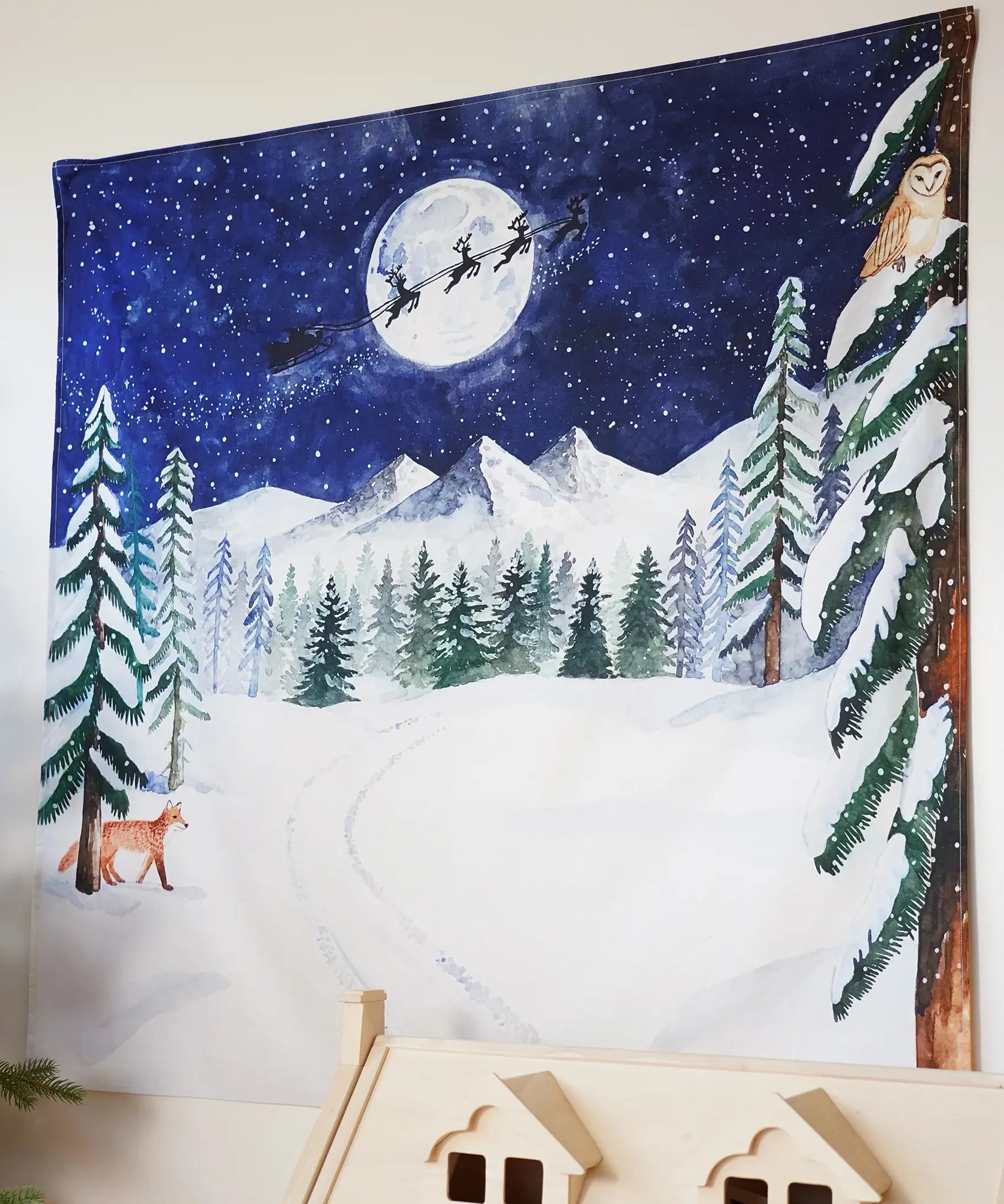 Wonderie Christmas Cotton Play Cloth, One Starry Winter's Night, a frosted forest scene with a full moon and Santa and his sleigh flying through the sky.