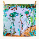 Wonderie Play Cloth - Down By The Pond. A beautiful play cloth depicting a busy pond scene with ducks, frogs, a heron, fish and dragonflies all playing among the reeds and lily pads