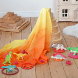 Wonderie organic cotton orange amber play cloth in volcano dinosaur small world set up using a Grimm's rainbow and Holzitger dinosaurs.