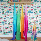Wonderie organic cotton play cloths in green, blue, yellow and pink in the Babipur playroom next to a Magic Wood marble tree and Grimm's rainbows.