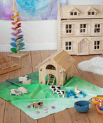 Wonderie organic cotton large sheer play cloth in juniper green used as grass in a farm small world play set up with Bbaipur animals and Lanka Kade barn.