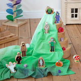 Wonderie organic cotton play cloth in green used for a Halloween play scene featuring Lanka Kade figures and a Grimm's rainbow.