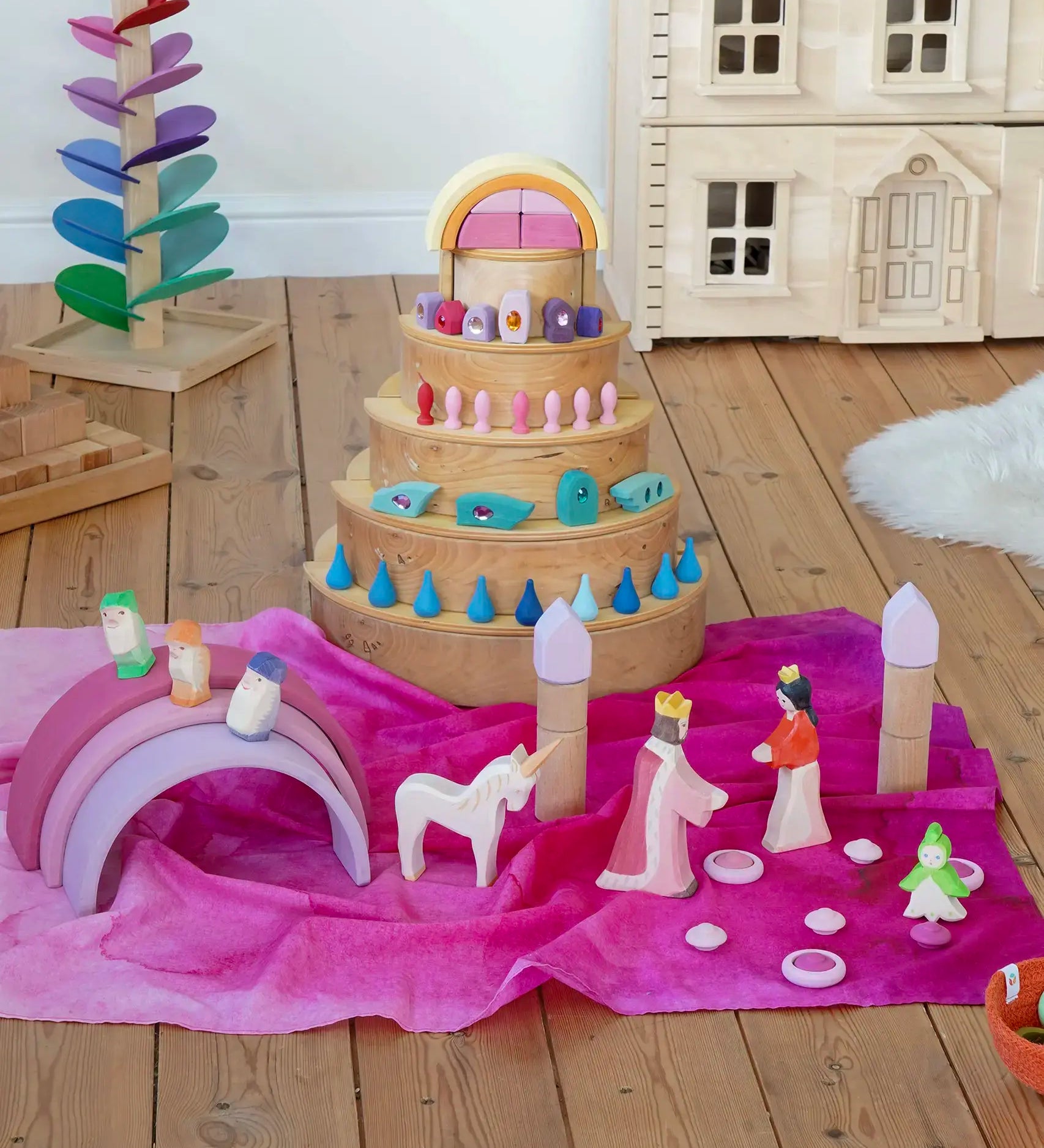 Wonderie organic cotton play cloth in pink used for a princess castle small world play scene featuring a Grimm's rainbow and Ostheimer fairytale figures.