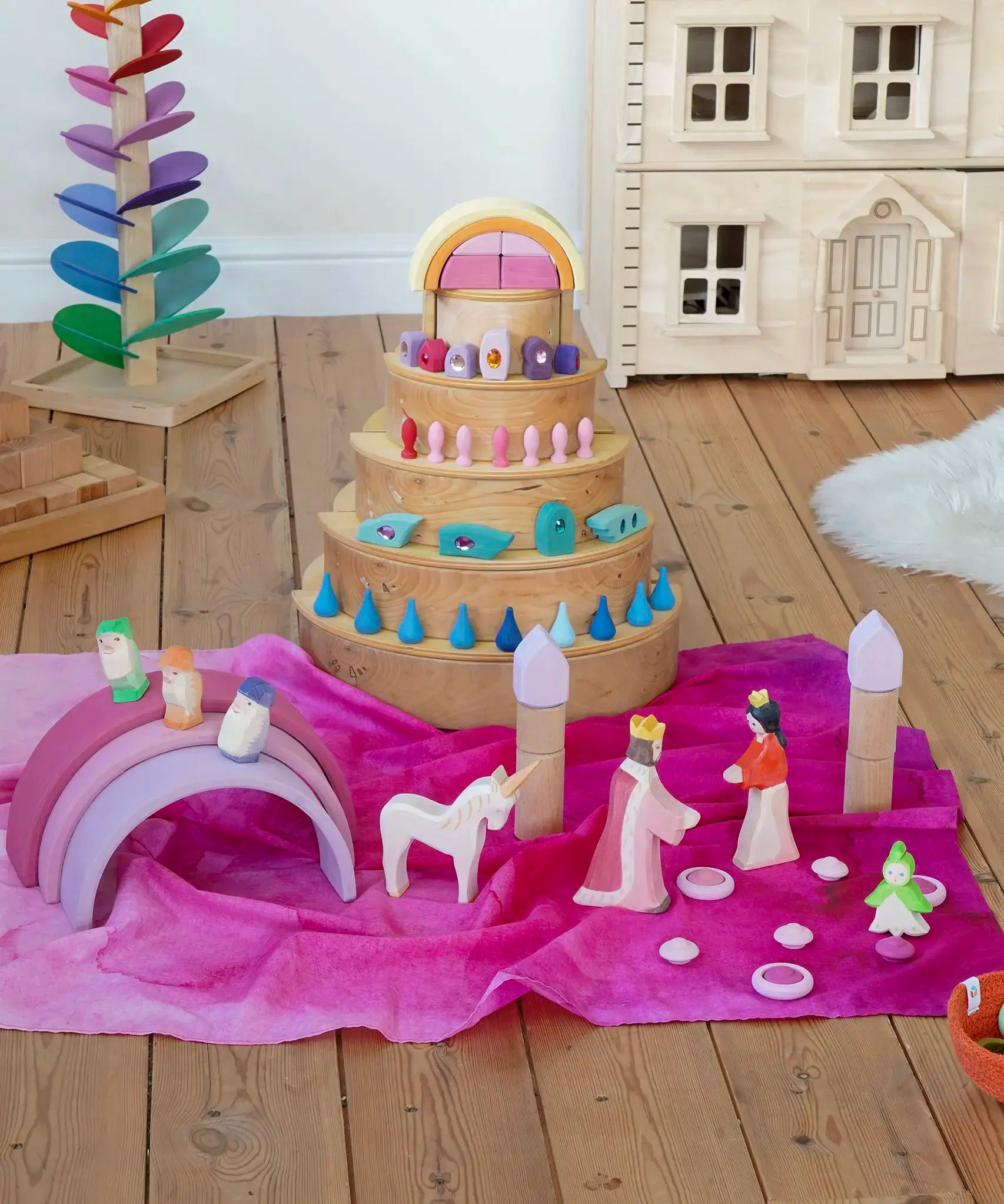 Wonderie organic cotton play cloth in pink used for a princess castle small world play scene featuring a Grimm's rainbow and Ostheimer fairytale figures.