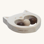 The side of the Wooden Story Smiley Cat Rattle, showing the natural wood grain of the rattle and the words "Wooden Story" etched into the side.