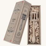 The Wooden Story Nighthawk Rattle comes in a vintage inspired, decorated cardboard box and is laid on wood shavings inside the box.