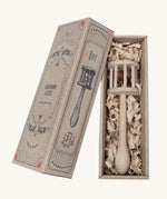 The Wooden Story Nighthawk Rattle comes in a vintage inspired, decorated cardboard box and is laid on wood shavings inside the box.