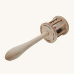 The underneath of the Wooden Story Nighthawk Rattle head, with the words "Wooden Story" etched onto the base. The image also shows the natural wood grain and is on a cream background