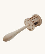 The underneath of the Wooden Story Nighthawk Rattle head, with the words "Wooden Story" etched onto the base. The image also shows the natural wood grain and is on a cream background