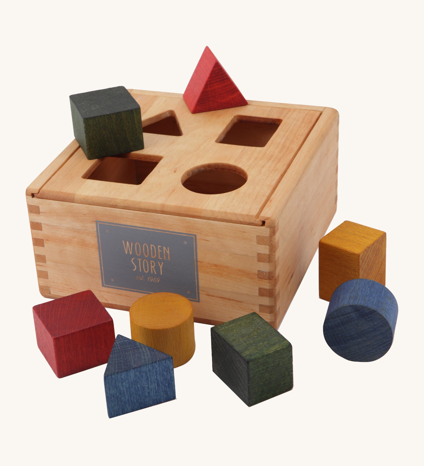 Wooden Story rainbow shape sorter box available at Babipur. Set comes with 8 different coloured shaped blocks and a natural unpainted box with cut out on the removable lid 