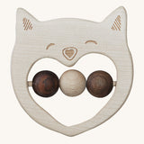The Wooden Story Smiley Cat Rattle, is a beautiful wooden, sensory toy, perfect for teething. The rattle has a cat face on the front, and three wooden beads in the middle. 2 in dark wood and 1 in light wood. The image is on a cream background