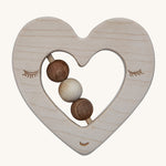 The Wooden Story Heart Rattle is a beautiful, sensory, wooden teething toy. The rattle is in a heart shaped design, with 3 wooden beads in the middle, and a face etched onto the front
