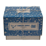 The Wooden Story Turtle Dove Rattle cardboard box, wrapped in string to make a beautiful gift, on a cream background