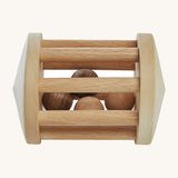 Wooden Story Turtle Dove Rattle, is a beautiful, wooden baby rattle toy. The wooden balls inside the rattle create a wonderful sensory experience for anyone playing with it. The image is on a cream background
