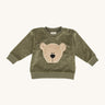 Wooly Organic embroidered sweater in tea leaf /savannah available at Babipur. A soft GOTS organic cotton jersey sweater in light green with a cute fluffy cream teddy bear on the front. Features popper fasteners on the shoulder for a easy fit