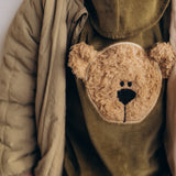 A close up of the cute fluffy cream teddy embroidery on the Wooly Organic  velour sweater in tea leaf /savannah available at Babipur. 