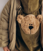 A close up of the cute fluffy cream teddy embroidery on the Wooly Organic  velour sweater in tea leaf /savannah available at Babipur. 