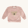 Wooly Organic embroidered velour sweater in pale blush pink /savannah available at Babipur. A soft GOTS organic cotton velour sweater in light pink with a cute fluffy cream teddy bear on the front.