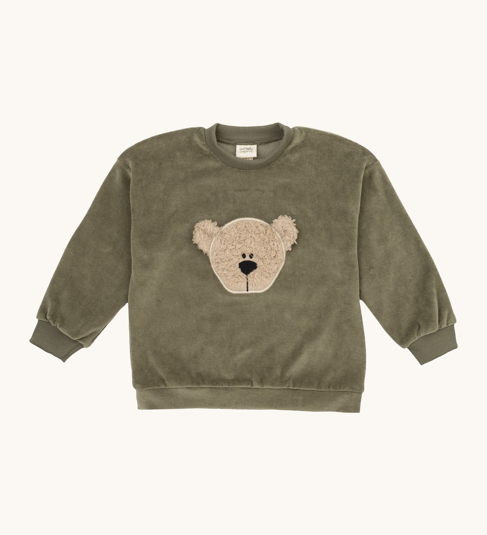 Wooly Organic embroidered velour sweater in tea leaf /savannah available at Babipur. A soft GOTS organic cotton velour sweater in light green with a cute fluffy cream teddy bear on the front.