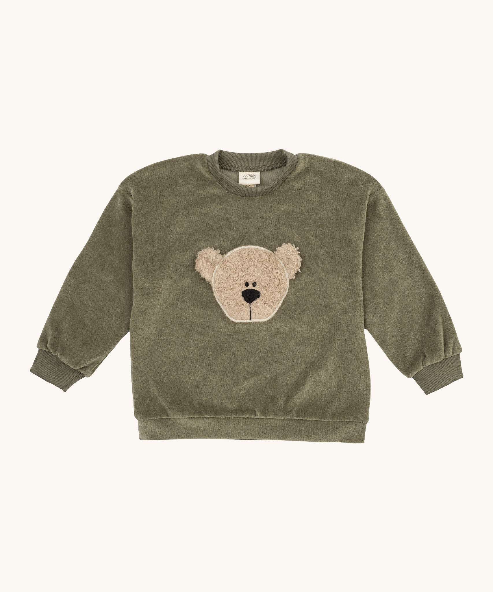 Wooly Organic embroidered velour sweater in tea leaf /savannah available at Babipur. A soft GOTS organic cotton velour sweater in light green with a cute fluffy cream teddy bear on the front.