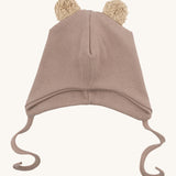Wooly Organic hat with teddy ears in pale blush / savannah available at Babipur. A light pink GOTS organic hat in a soft ribbed style. Features ties and cute fluffy brown teddy bear ears
