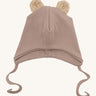 Wooly Organic hat with teddy ears in pale blush / savannah available at Babipur. A light pink GOTS organic hat in a soft ribbed style. Features ties and cute fluffy brown teddy bear ears