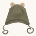 Wooly Organic hat with teddy ears in tea leaf / savannah available at Babipur. A light green GOTS organic hat in a soft ribbed style. Features ties and cute fluffy brown teddy bear ears