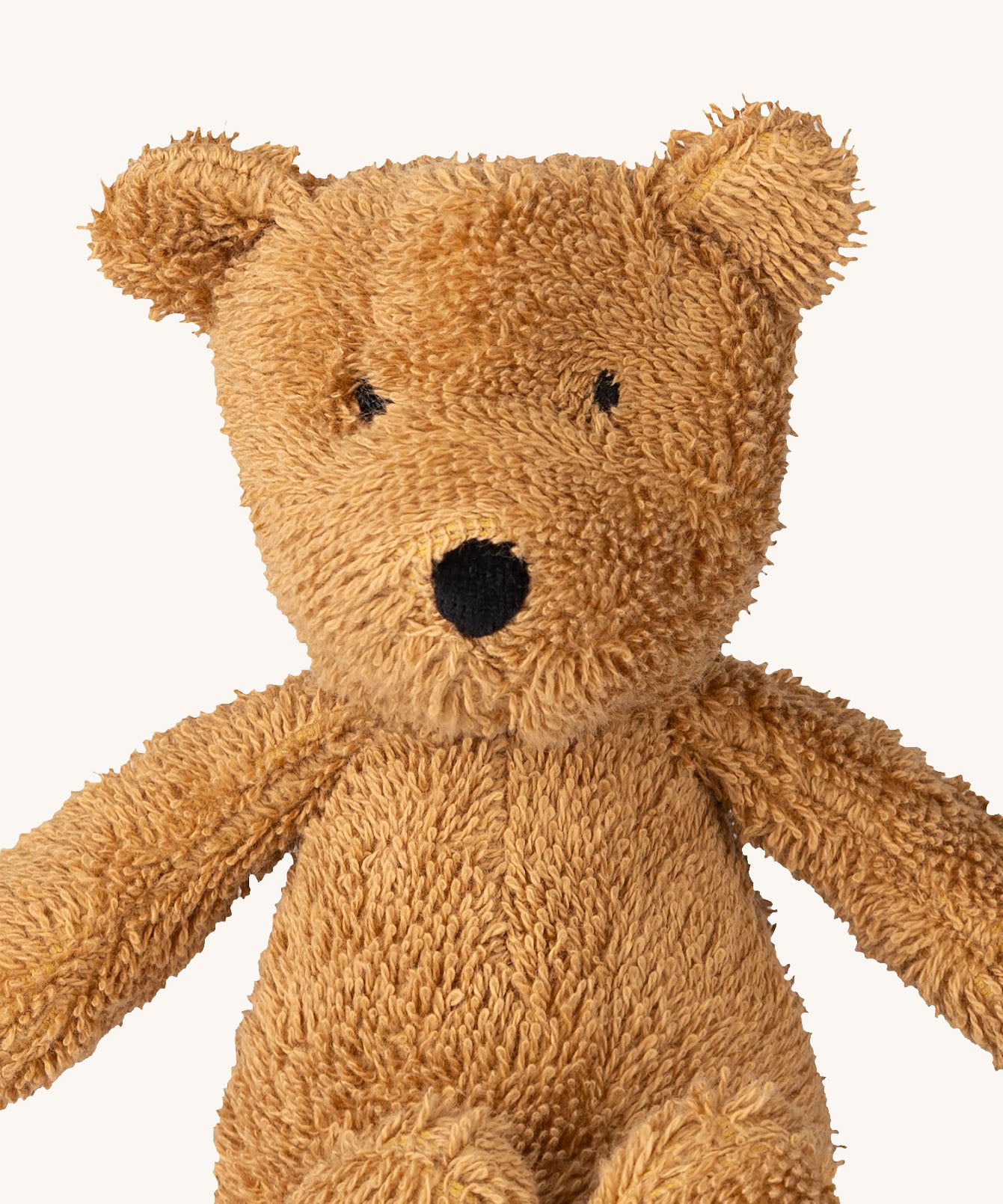 A close up of the A small Wooly Organic soft teddy bear in brown available at Babipur showing the cute facial features