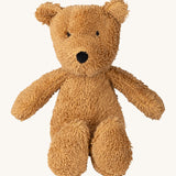 A small Wooly Organic soft teddy bear in brown available at Babipur. A soft cotton brown teddy bear with cute facial features