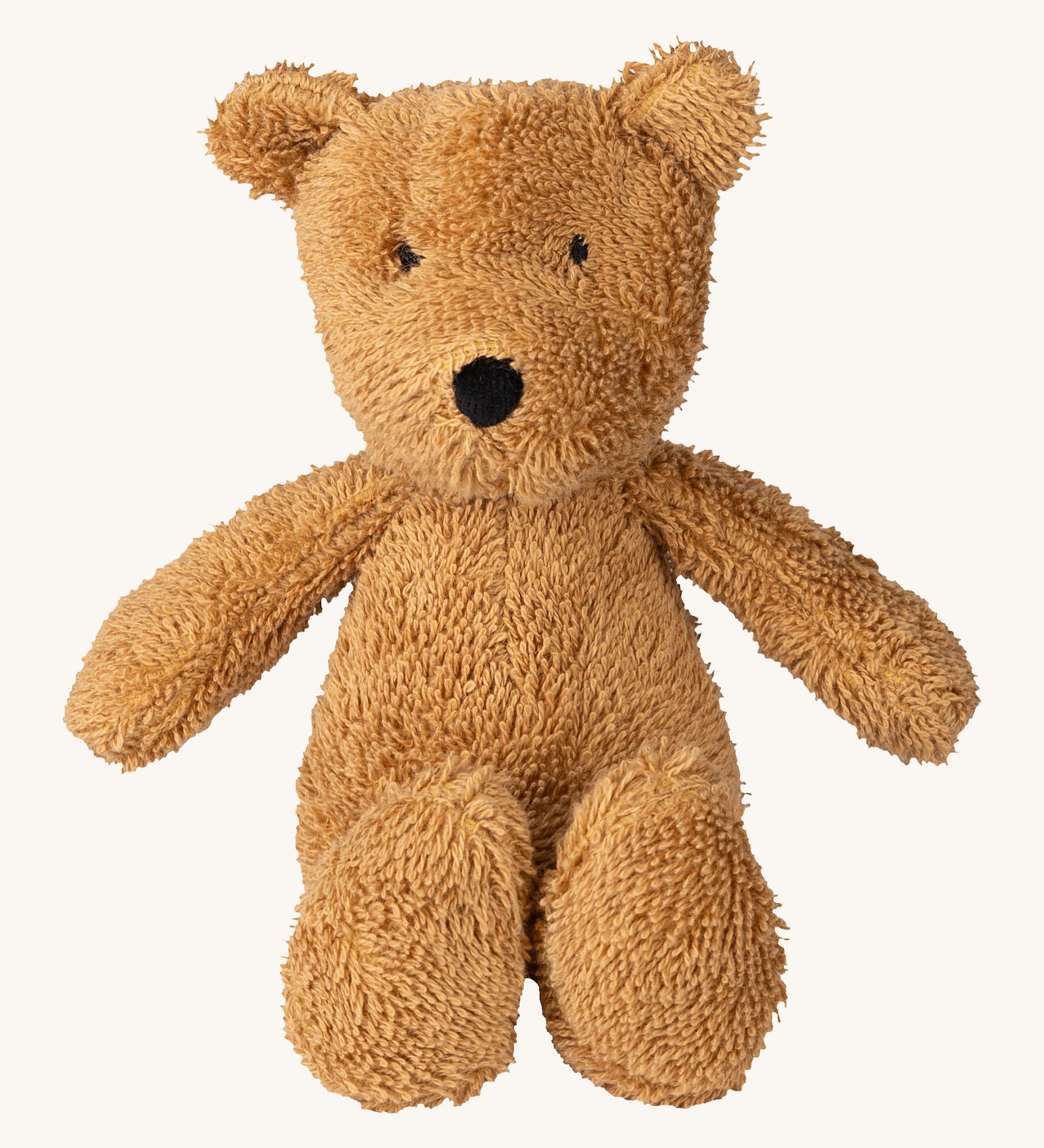 A small Wooly Organic soft teddy bear in brown available at Babipur. A soft cotton brown teddy bear with cute facial features