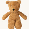 A small Wooly Organic soft teddy bear in brown available at Babipur. A soft cotton brown teddy bear with cute facial features
