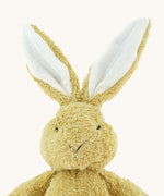 A close up of the small Wooly Organic soft bunny rabbit in amber available at Babipur showing the cute facial features and floppy ears