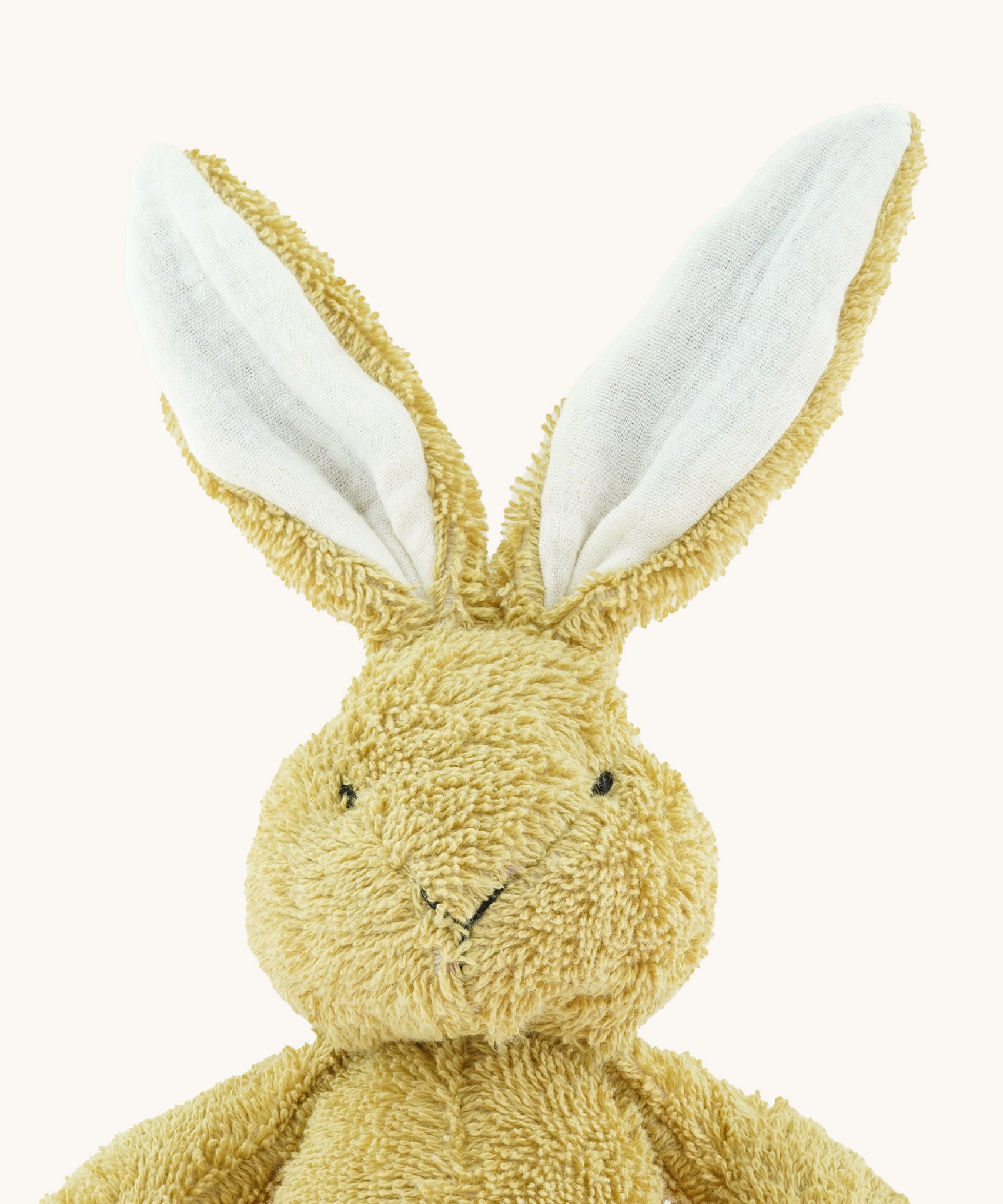 A close up of the small Wooly Organic soft bunny rabbit in amber available at Babipur showing the cute facial features and floppy ears