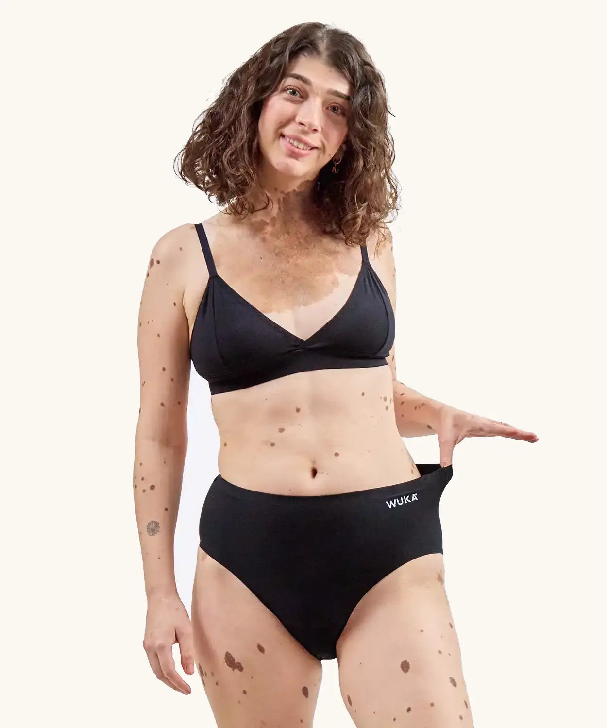 Woman wearing the WUKA Stretch Cotton Midi Brief Period Pants Black - Heavy Flow 