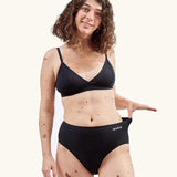 Woman wearing the WUKA Stretch Cotton Midi Brief Period Pants Black - Heavy Flow 