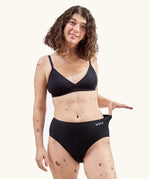 Woman wearing the WUKA Stretch Cotton Midi Brief Period Pants Black - Heavy Flow 