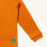 A closer look at the waffle texture fabric of the LGR Long Sleeve Waffle Top - Golden Ochre